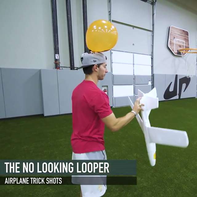 One of Dude Perfect's twins prepares for The No Looking Looper trick shot with styrofoam glider